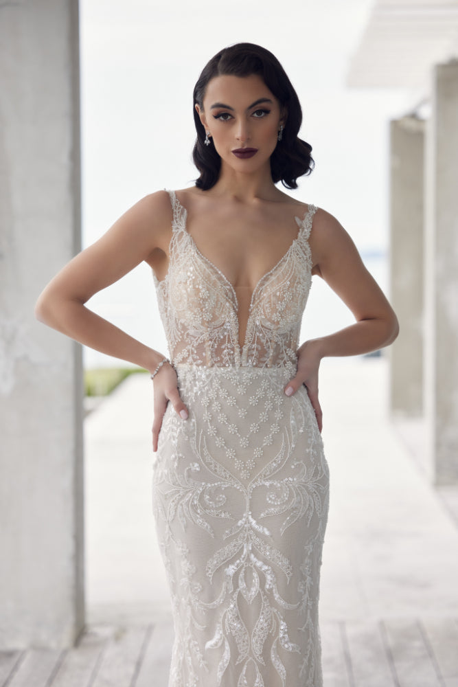 Tala gown in champagne colour. Adorned in floral and leafy beaded and sequined motifs. Plunging v-neckline with illusion mesh and sheer bodice.