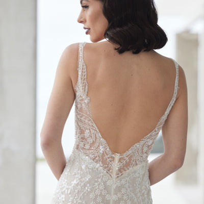 Back of tala gown showing leafy and floral beaded details on plunging backline.
