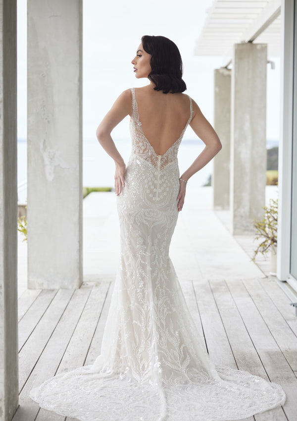 Back view of Tala gown, beaded and sequined in floral and leafy motifs. Plunging back with beaded train.