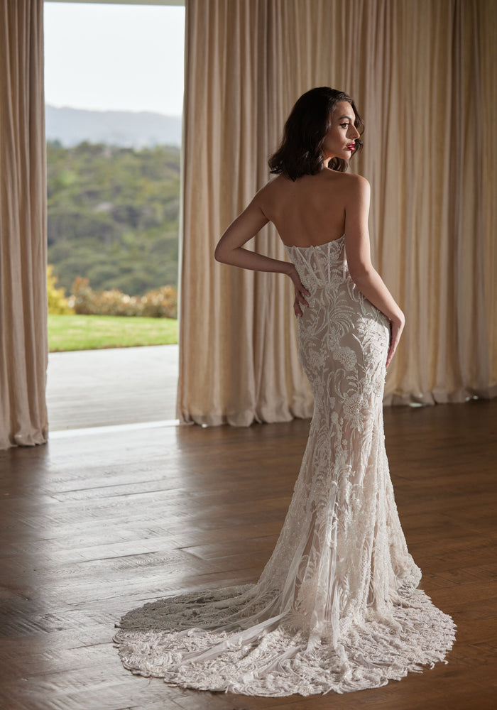Heavily beaded trumpet silhouette strapless gown. Back view of Tay without tulle straps.