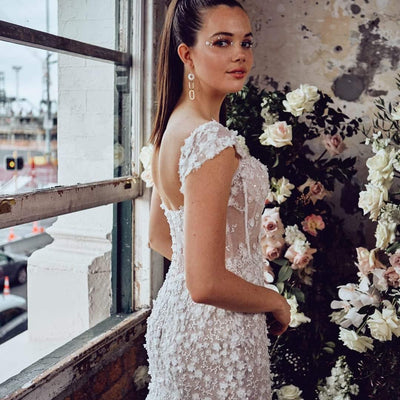 Off-the-shoulder sweetheart fit-and-flare wedding dress with floral lace detail.