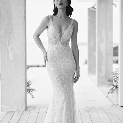 Black and white image of Tala gown. Fit-n-flare silhouette with floral and leafy beaded motifs and plunging v-neckline.