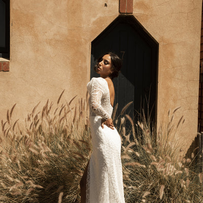 Side view of Rachel dress with scooped backline and beaded mutton sleeve.