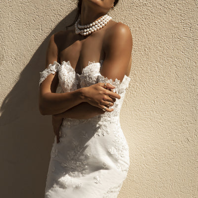 Close up of Roberta gown with floral lace detailing and floral off the shoulder straps.