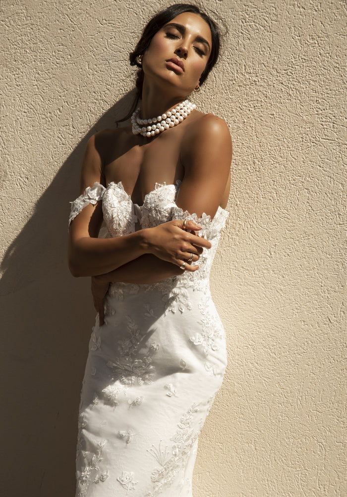 Close up of Roberta gown with floral lace detailing and floral off the shoulder straps.