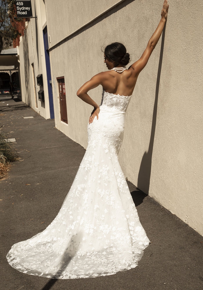 Back view of Roberta gown with detachable straps removed. Floral beaded lace extends the full length of gown and down train.