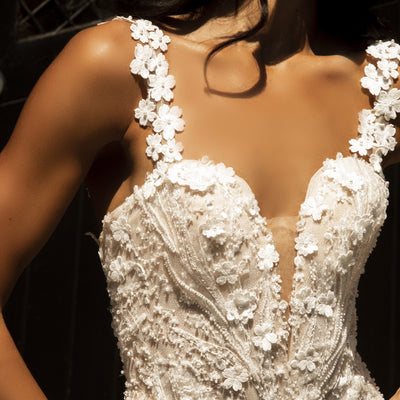 Close up of Louise dress bodice made with 3D flowers and beaded lace. Plunging sweetheart neckline with illusion mesh and 3D floral straps.