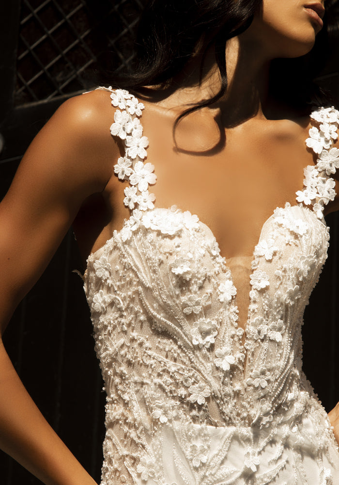 Close up of Louise dress bodice made with 3D flowers and beaded lace. Plunging sweetheart neckline with illusion mesh and 3D floral straps.