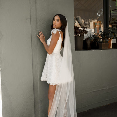 Mini dress with shoulder bows and a-line 3D floral skirt with long tulle veil.