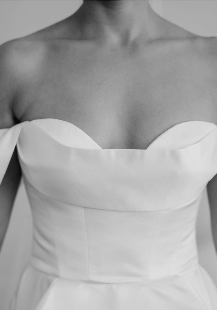 Off-the-shoulder white satin high slit wedding dress.